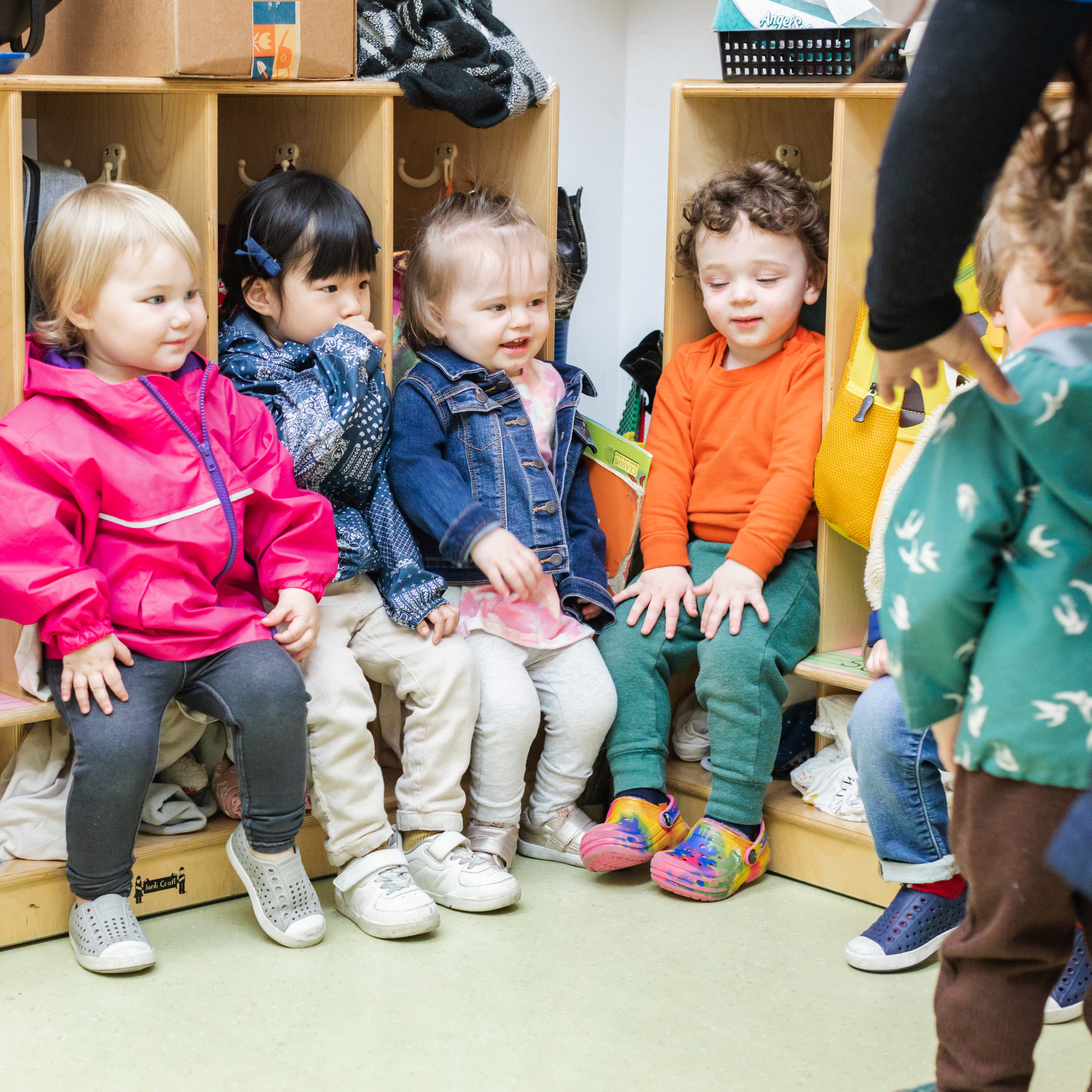 A group of children sitting on top of a bench.