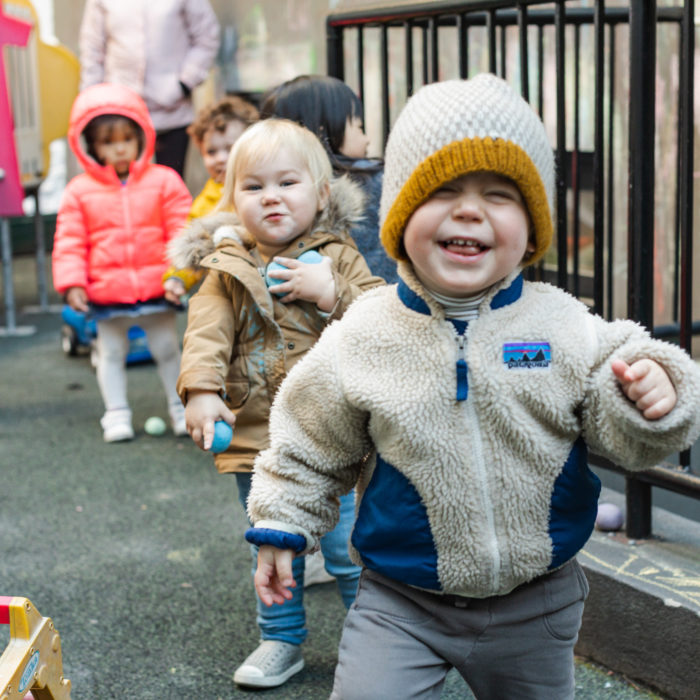 A group of children walking down the street.