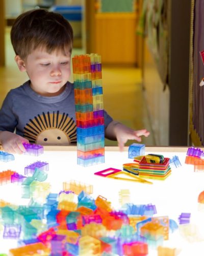 A boy playing with blocks at the table