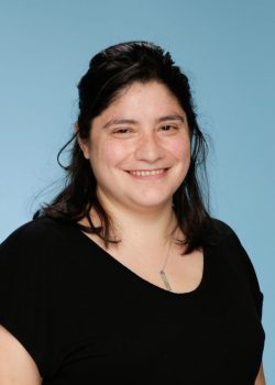 A woman with long hair wearing black shirt.